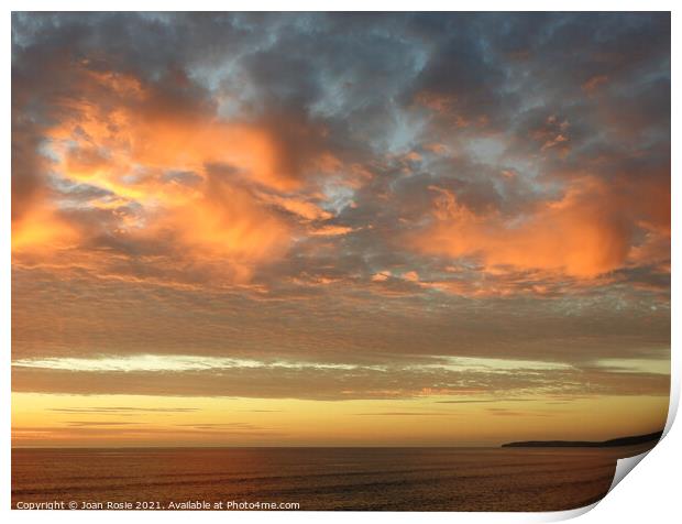 Spectacular red clouds at sunset in North Devon Print by Joan Rosie