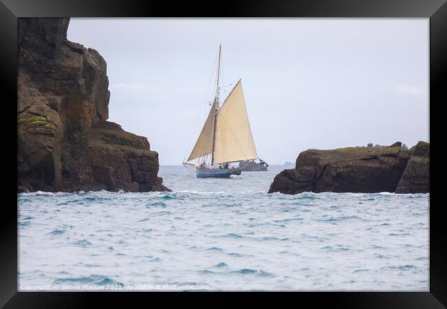 Yacht sailing between rocks in the Isles of Scilly Framed Print by Simon Marlow