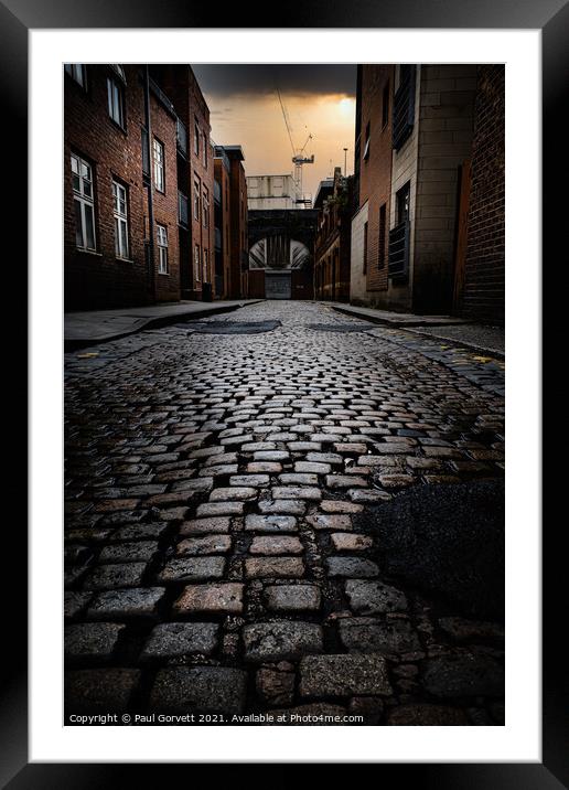 wet cobbled street in Manchester city center UK Framed Mounted Print by Paul Gorvett
