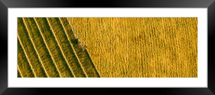 Aerial view of a agricultural machine during hay production.  Framed Mounted Print by Andrea Obzerova