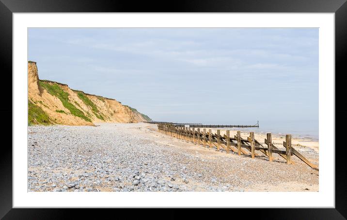 Pebbles and sea defences at West Runton beach Framed Mounted Print by Jason Wells