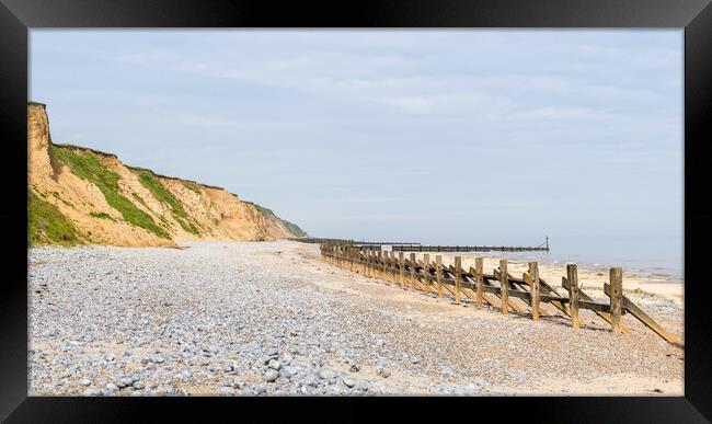 Pebbles and sea defences at West Runton beach Framed Print by Jason Wells
