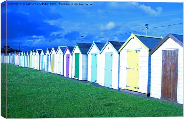 Coloured wooden beach huts in Paignton, Devon Canvas Print by SIMON STAPLEY