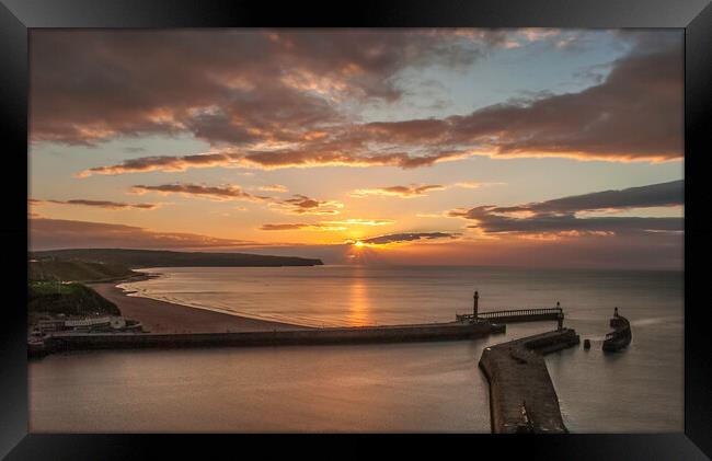 Sunset over Whitby piers Framed Print by Andrew Sharpe