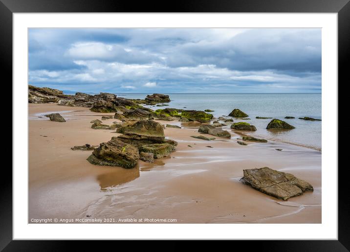Rocks on Dornoch beach in Sutherland, Scotland Framed Mounted Print by Angus McComiskey
