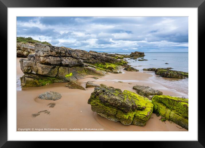 Outcrop of rock on Dornoch beach in Sutherland Framed Mounted Print by Angus McComiskey