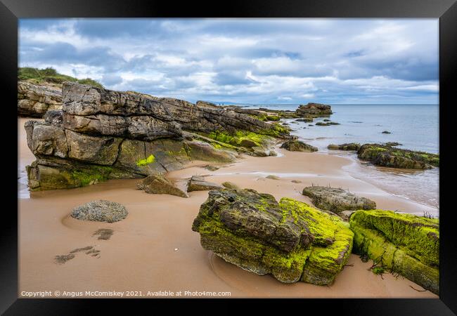 Outcrop of rock on Dornoch beach in Sutherland Framed Print by Angus McComiskey