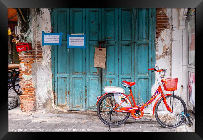 Red bicycle parked by blue doors Framed Print by Kevin Hellon