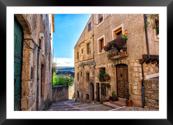medieval city street with stone buildings Framed Mounted Print by David Galindo