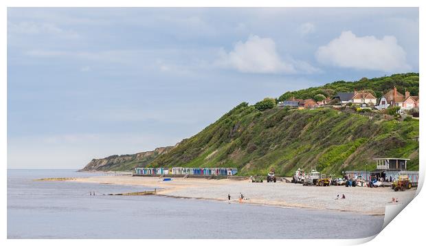 Beach huts sandwiched between the sea and cliffs at Cromer Print by Jason Wells