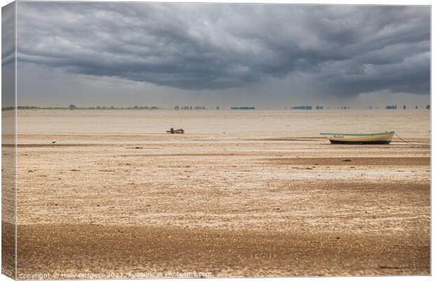 Norfolk coast with storm in the back over the sea boats moored on the sandy beach  Canvas Print by Holly Burgess