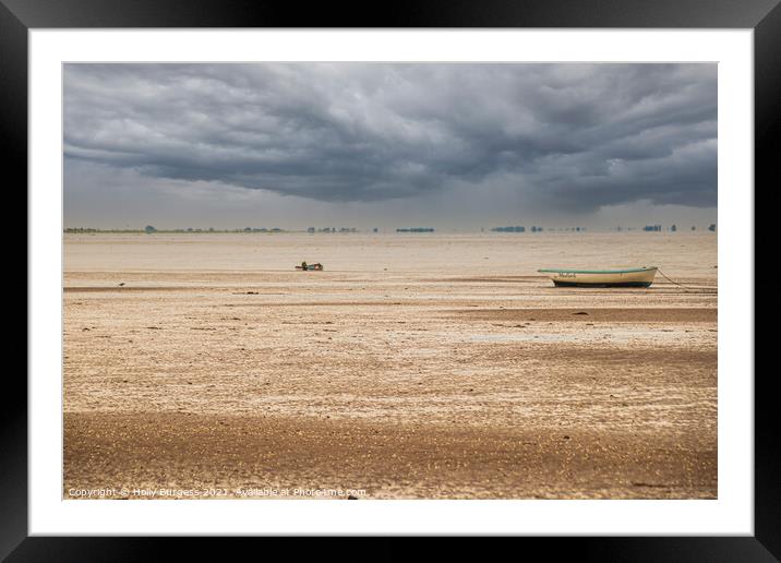 Norfolk coast with storm in the back over the sea boats moored on the sandy beach  Framed Mounted Print by Holly Burgess