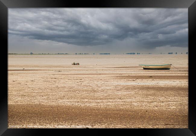 Norfolk coast with storm in the back over the sea boats moored on the sandy beach  Framed Print by Holly Burgess