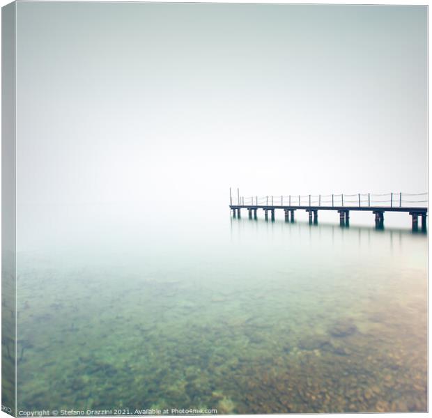 Pier in a foggy day. Lake Garda Canvas Print by Stefano Orazzini