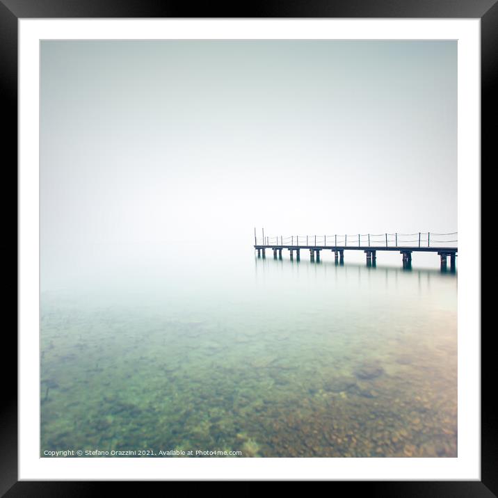 Pier in a foggy day. Lake Garda Framed Mounted Print by Stefano Orazzini