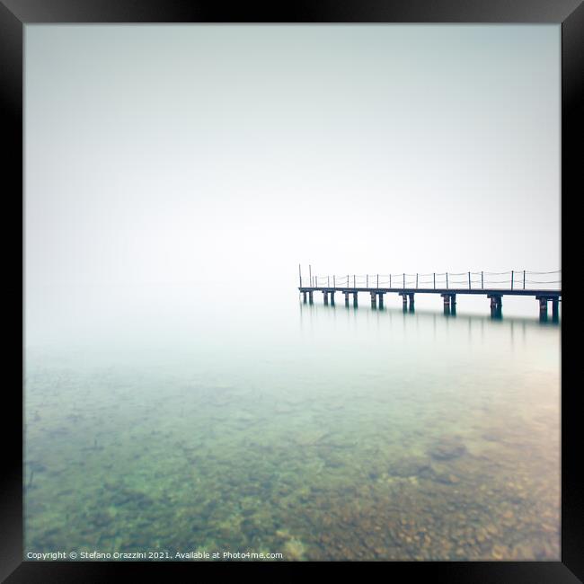 Pier in a foggy day. Lake Garda Framed Print by Stefano Orazzini