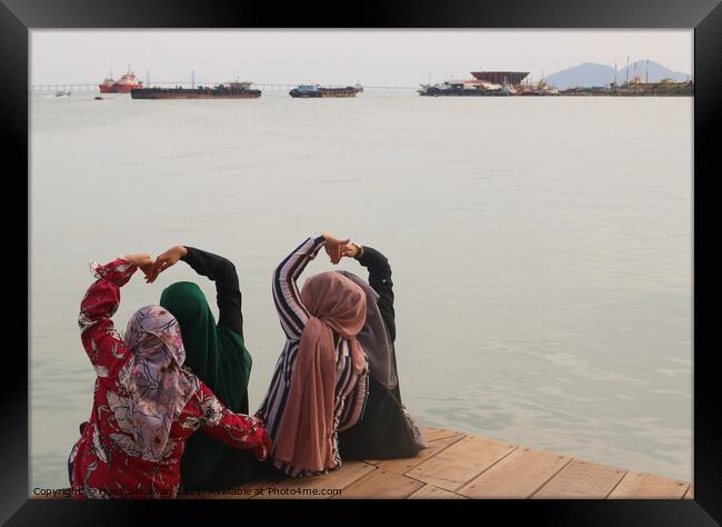 Heart shapes shown from four Moslem women. Framed Print by Hanif Setiawan