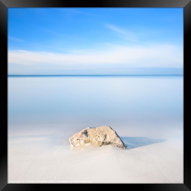 Rock on a white sandy beach Framed Print by Stefano Orazzini