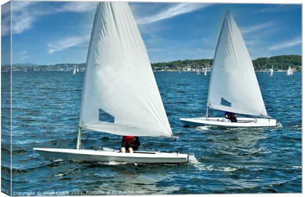 Teens racing in small sailboat with white sails. Canvas Print by Geoff Childs