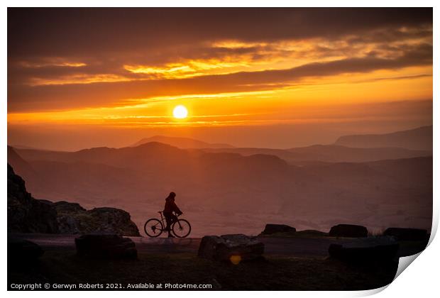 Cyclist's silhouette durning Sunrise Print by Gerwyn Roberts