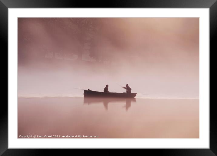 People fishing from a boat on a misty lake at dawn. Framed Mounted Print by Liam Grant