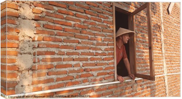 A Caucasian man in window with conical hat. Canvas Print by Hanif Setiawan