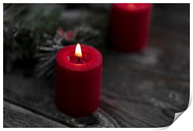 Close up of single red glowing candle with fir and wood dark bac Print by Thomas Baker