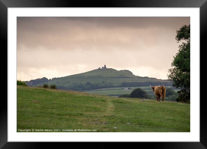 Serene Highland Cow at Brentor Church Framed Mounted Print by Martin Yiannoullou