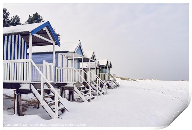 Beach huts covered in snow at low tide. Wells-next-the-sea, Norf Print by Liam Grant