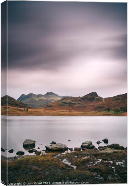 Clouds over Blea Tarn with Langdale Pikes beyond. Canvas Print by Liam Grant
