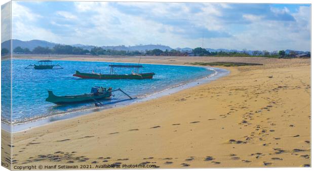 Longtail fishing boats at sand beach Canvas Print by Hanif Setiawan