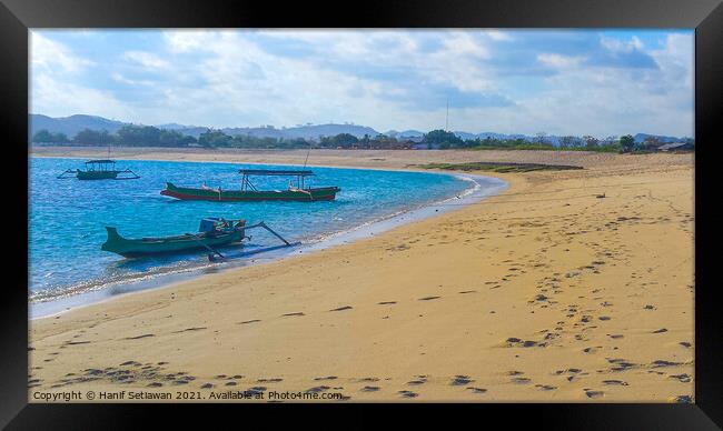 Longtail fishing boats at sand beach Framed Print by Hanif Setiawan