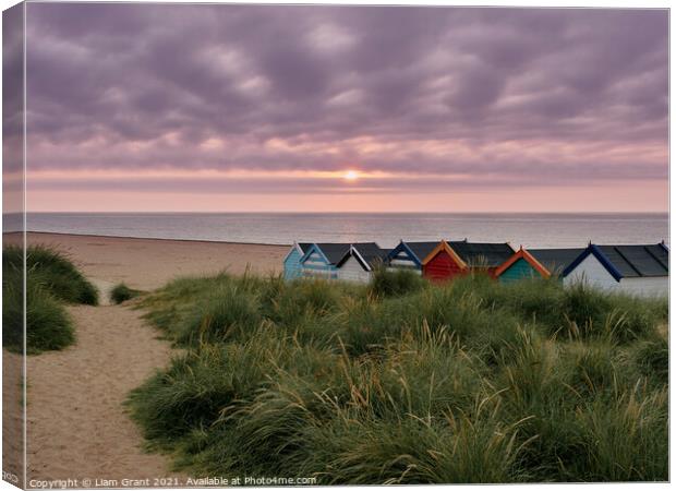 UK, Suffolk, Southwold, Sunrise over multi coloured beach huts Canvas Print by Liam Grant