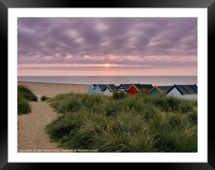 UK, Suffolk, Southwold, Sunrise over multi coloured beach huts Framed Mounted Print by Liam Grant