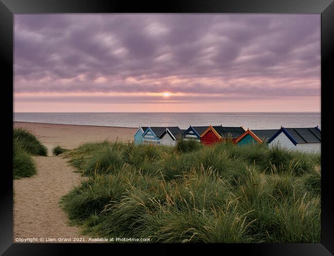 UK, Suffolk, Southwold, Sunrise over multi coloured beach huts Framed Print by Liam Grant
