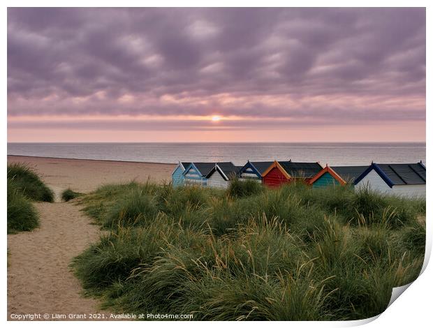 UK, Suffolk, Southwold, Sunrise over multi coloured beach huts Print by Liam Grant