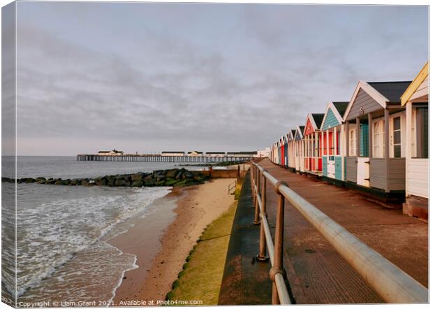 UK, Suffolk, Southwold pier and colourful beach huts at sunrise Canvas Print by Liam Grant