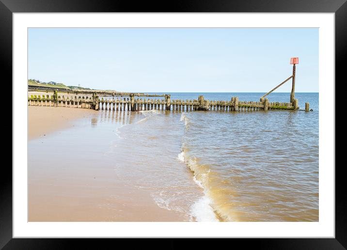 Waves lap up against the beach at Cart Gap Framed Mounted Print by Jason Wells