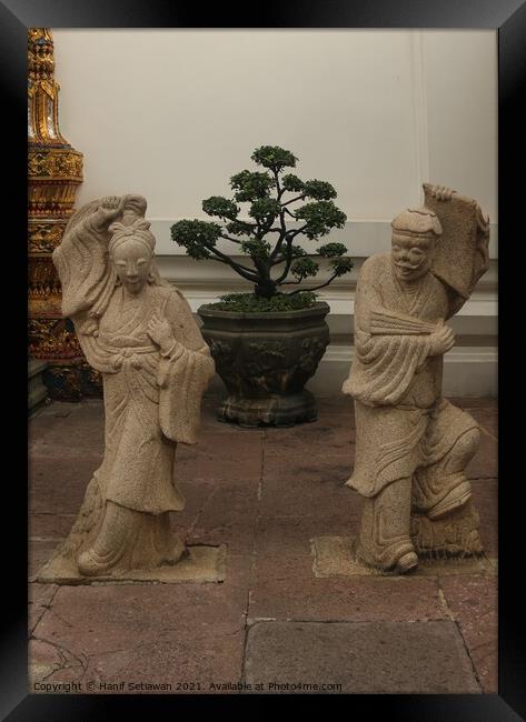 Stone sculptures art from Asian woman and man. Framed Print by Hanif Setiawan