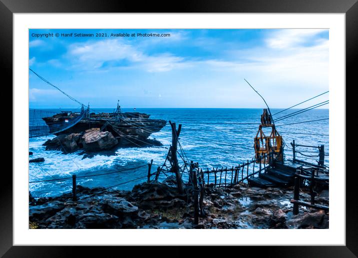 Swinging rope foot bridge and cable car to a rock  Framed Mounted Print by Hanif Setiawan