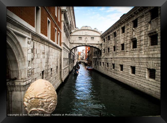 Gondolas on the canal under the bridge of sighs Framed Print by Ann Biddlecombe