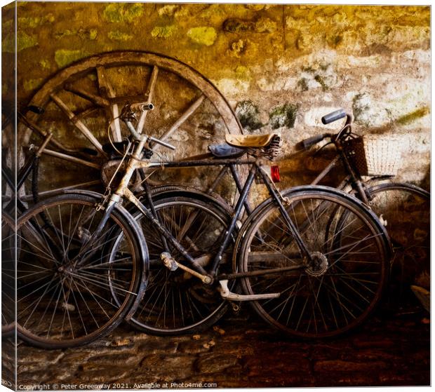 Old Pedal Cycles Propped Up Against A Barn Wall Canvas Print by Peter Greenway
