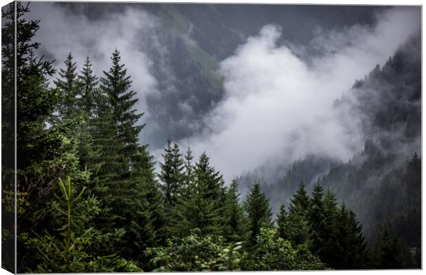 A rainy day in the Austrian Alps with deep clouds and fog Canvas Print by Erik Lattwein