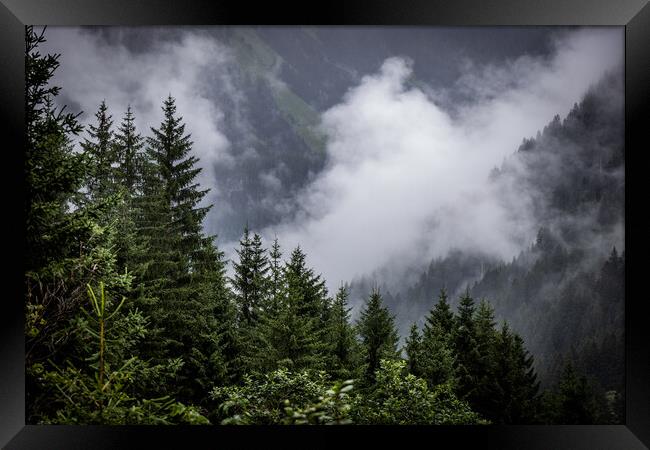 A rainy day in the Austrian Alps with deep clouds and fog Framed Print by Erik Lattwein