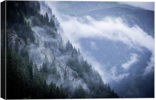 A rainy day in the Austrian Alps with deep clouds and fog Canvas Print by Erik Lattwein