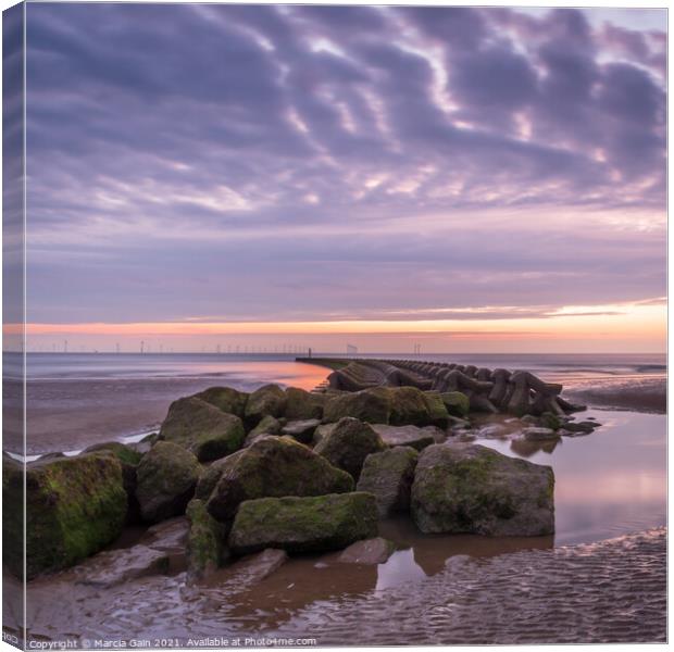 Breakwater at sunset Canvas Print by Marcia Reay