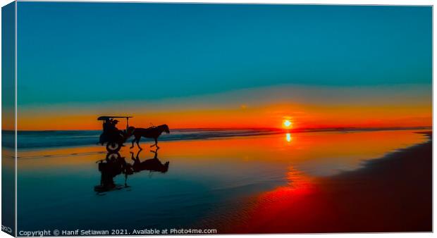 Horse-drawn carriage at sunset on beach Canvas Print by Hanif Setiawan