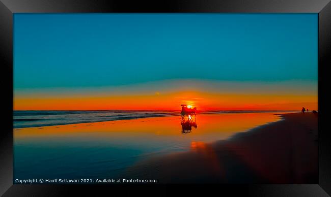 Horse-drawn carriage at sunset on beach Framed Print by Hanif Setiawan