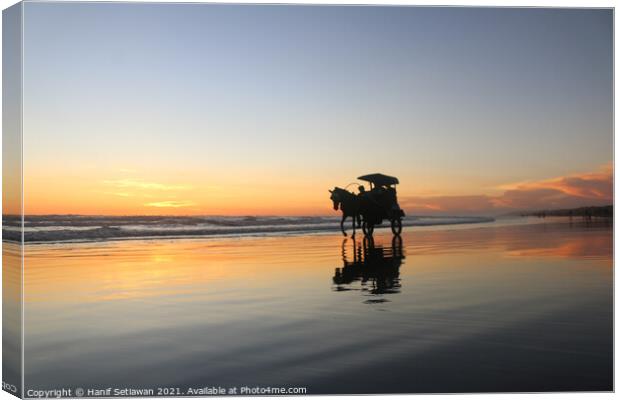 Horse-drawn carriage at sunset on beach Canvas Print by Hanif Setiawan