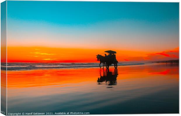 Horse-drawn carriage at sunset on beach Canvas Print by Hanif Setiawan